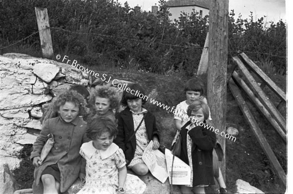 CHILDREN WAITING IN GROUP AT SIDE OF ROAD